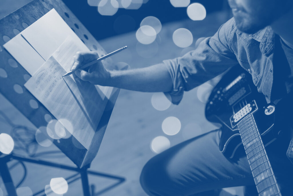 An e-guitar player composing music