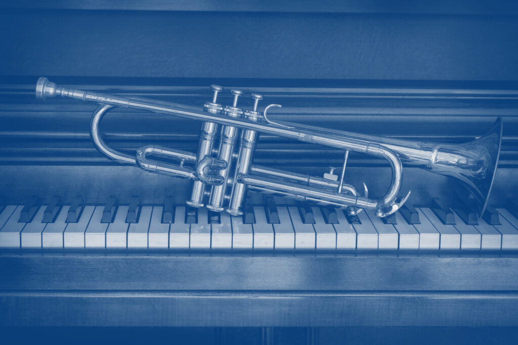 Eine Trompete, die auf einem Klavier liegt